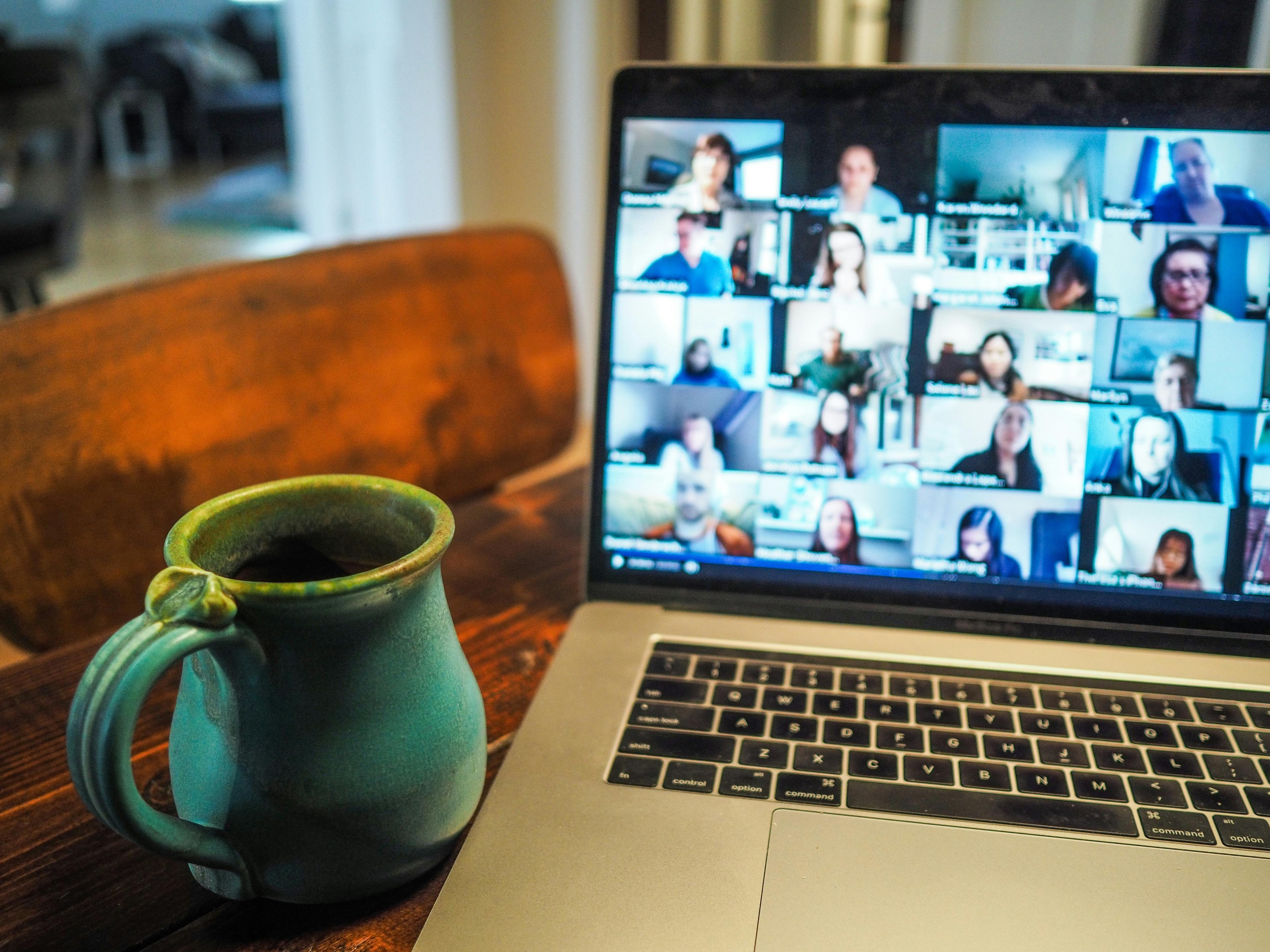 Image of diverse team on a virtual meeting with transcription tools up on their screens